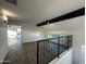 Bright loft area with wood flooring and a black accent beam at 8050 E Tuckey Ln, Scottsdale, AZ 85250