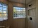 Clean shower with glass block windows and modern fixtures at 8050 E Tuckey Ln, Scottsdale, AZ 85250