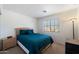 Cozy bedroom with a teal comforter and neutral decor at 1041 W Chilton Ave, Gilbert, AZ 85233