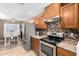 Bright kitchen with stainless steel appliances and wood cabinets at 12640 W Florence St, Avondale, AZ 85323