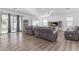 Comfortable living room featuring wood floors, a ceiling fan, and a glass door at 3121 E Powell Way, Gilbert, AZ 85298