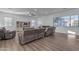 Bright living room with wood floors, a ceiling fan, and a large window at 3121 E Powell Way, Gilbert, AZ 85298