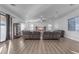 Spacious living room features wood floors and large windows at 3121 E Powell Way, Gilbert, AZ 85298