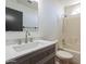 Updated bathroom with a vanity, quartz countertop, and bathtub at 7313 N 69Th Ave, Glendale, AZ 85303