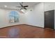 Bedroom with hardwood floors, ceiling fan and large window at 7313 N 69Th Ave, Glendale, AZ 85303