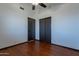 Well-lit bedroom with wood floors, a ceiling fan, and double door closet at 7313 N 69Th Ave, Glendale, AZ 85303