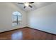 Bedroom featuring wood floors, arched window, and ceiling fan at 7313 N 69Th Ave, Glendale, AZ 85303