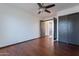 Bright bedroom with wood floors, ceiling fan, and double door closet at 7313 N 69Th Ave, Glendale, AZ 85303