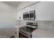 Modern kitchen with stainless steel appliances and white cabinets at 7313 N 69Th Ave, Glendale, AZ 85303