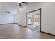 Spacious living room with wood-look tile floors and sliding glass door at 7313 N 69Th Ave, Glendale, AZ 85303