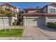 Two story stucco townhome with attached two car garage and front landscaping at 1108 W Mango Dr, Gilbert, AZ 85233