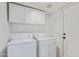 Laundry room with washer, dryer and overhead cabinets at 1108 W Mango Dr, Gilbert, AZ 85233