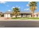 Single story home with a well maintained lawn and palm trees at 114 W Ivanhoe Pl, Chandler, AZ 85225