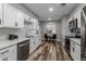 Modern kitchen with white cabinets, hexagon tile backsplash, and stainless steel appliances at 114 W Ivanhoe Pl, Chandler, AZ 85225