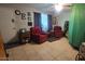 Living room featuring two red armchairs and tiled floors at 2331 W Via Rialto Cir, Mesa, AZ 85202