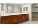 Double vanity bathroom with wood cabinets and tile floor at 26535 W Ponderosa Ln, Buckeye, AZ 85396