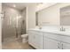 A bright bathroom with double vanity, large mirror and glass door shower at 2848 N Evergreen St, Buckeye, AZ 85396