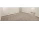 A neutral bedroom with light carpet and bright white trim and white walls at 2848 N Evergreen St, Buckeye, AZ 85396