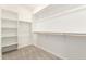 Bright walk-in closet with shelving, hanging rods, and carpet at 2848 N Evergreen St, Buckeye, AZ 85396