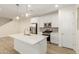 Bright and airy kitchen boasts stainless appliances, white cabinetry, and a spacious center island at 2848 N Evergreen St, Buckeye, AZ 85396
