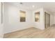 Bright living area showcasing wood-look floors, multiple windows, and sliding glass door access at 2848 N Evergreen St, Buckeye, AZ 85396