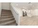 Open concept living space with stairway, wood-look floors, and a modern kitchen in the background at 2848 N Evergreen St, Buckeye, AZ 85396