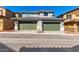 Street view showcasing homes with two-car garages, landscaped front yards, and a contemporary design at 2848 N Evergreen St, Buckeye, AZ 85396