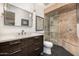 Modern bathroom with a sleek vanity, a glass-enclosed shower, and stylish black floors at 629 E Myrtle Ave, Phoenix, AZ 85020