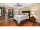 Cozy bedroom with dark wood floors, a ceiling fan, and courtyard access at 629 E Myrtle Ave, Phoenix, AZ 85020