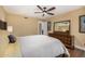 Bedroom with ceiling fan, dark wood floors, and a mirrored dresser at 629 E Myrtle Ave, Phoenix, AZ 85020