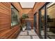 Private courtyard features wood walls, a fountain, and lush plants at 629 E Myrtle Ave, Phoenix, AZ 85020