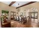 Dining room featuring wood beams, terracotta tile flooring, and a stylish light fixture at 629 E Myrtle Ave, Phoenix, AZ 85020