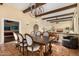 Elegant dining room features a rustic table, chairs, and decorative lighting fixture at 629 E Myrtle Ave, Phoenix, AZ 85020