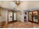 Welcoming entryway with tile flooring, doors to the backyard, and access to the laundry room at 629 E Myrtle Ave, Phoenix, AZ 85020