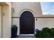 Front entry featuring a decorative iron gate, potted plants, and an ADT security sign at 629 E Myrtle Ave, Phoenix, AZ 85020