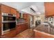 Kitchen boasts modern appliances, wood cabinetry, and a view into the dining room at 629 E Myrtle Ave, Phoenix, AZ 85020