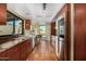 Galley kitchen with stainless steel appliances, granite counters, and ample natural light at 629 E Myrtle Ave, Phoenix, AZ 85020