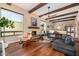 Inviting living room featuring a fireplace, wood beams, large windows and comfortable seating at 629 E Myrtle Ave, Phoenix, AZ 85020