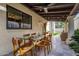 Outdoor covered patio with dining table and wicker furniture at 629 E Myrtle Ave, Phoenix, AZ 85020