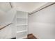 Open walk-in closet with white shelving and wooden closet rods at 629 E Myrtle Ave, Phoenix, AZ 85020