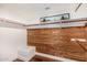 Custom walk-in closet with wood paneling and a white storage bench at 629 E Myrtle Ave, Phoenix, AZ 85020