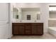 Double sink bathroom vanity with modern wood cabinets and mirrors at 7280 E White Tail Rd, San Tan Valley, AZ 85143