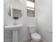Modern bathroom featuring pedestal sink, toilet and updated fixtures at 7280 E White Tail Rd, San Tan Valley, AZ 85143