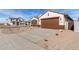 New construction home with brown garage door and driveway at 7280 E White Tail Rd, San Tan Valley, AZ 85143