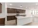 Modern kitchen with dark cabinets, island, and stainless steel appliances at 7280 E White Tail Rd, San Tan Valley, AZ 85143