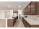 Modern kitchen with dark cabinets and an island at 7280 E White Tail Rd, San Tan Valley, AZ 85143