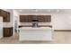 Modern kitchen with island and dark brown cabinets at 7280 E White Tail Rd, San Tan Valley, AZ 85143