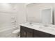 Modern bathroom featuring a dual sink vanity, white countertop, and shower over tub at 16032 W Desert Hollow Dr, Surprise, AZ 85387