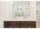 Bathroom featuring double sinks with walk-in shower at 16032 W Desert Hollow Dr, Surprise, AZ 85387