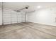 Spacious two-car garage with concrete floors and white insulated garage door at 16032 W Desert Hollow Dr, Surprise, AZ 85387